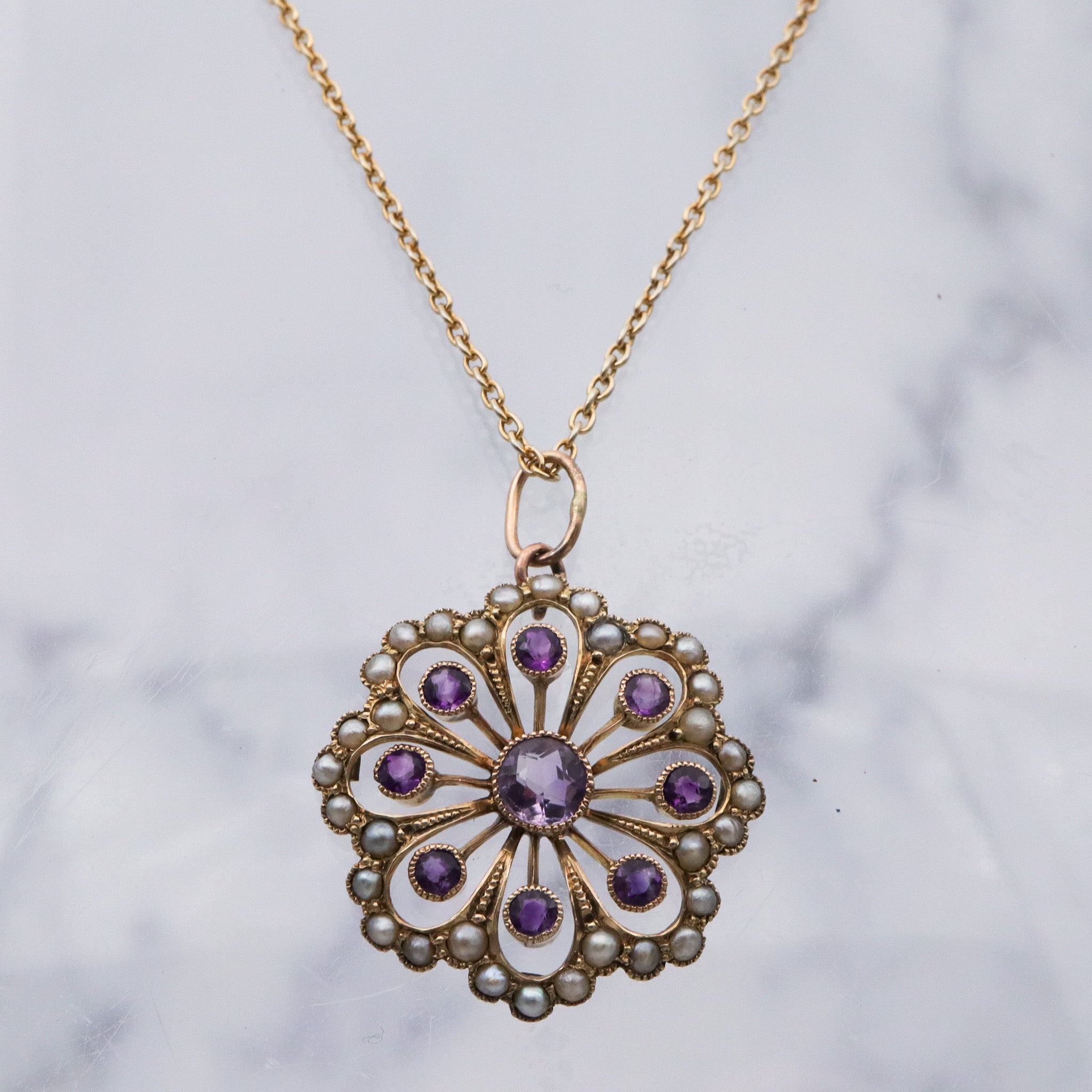 Antique early Victorian 9k gold, amethyst and split pearl flower pendant
